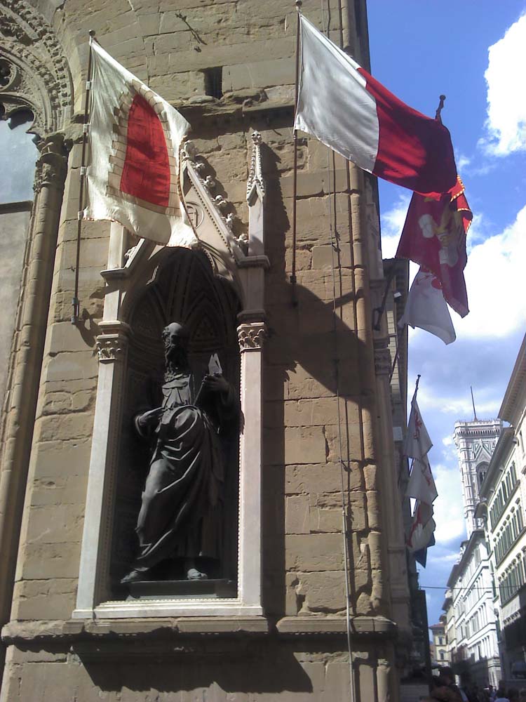 The statue of John the Evangelist, commissioned by the silk traders, symbolized by the gate they brought their goods through.