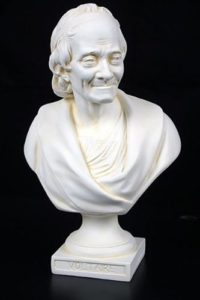 Bust of voltaire, smiling.